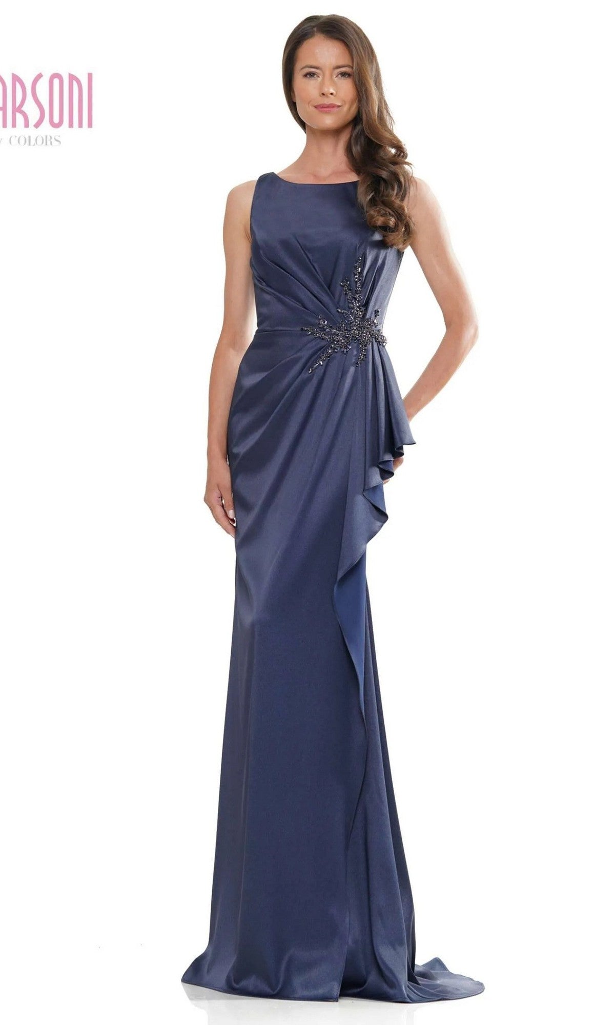 A woman models the Marsoni MV1233 long formal dress in navy, featuring a sleeveless, floor-length design with draped faille fabric and beaded details, standing against a plain white background.